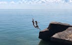 Two girls dive into Lake Superior at Madeline Island's Big Bay State Park. Photo by Martha Sanchez