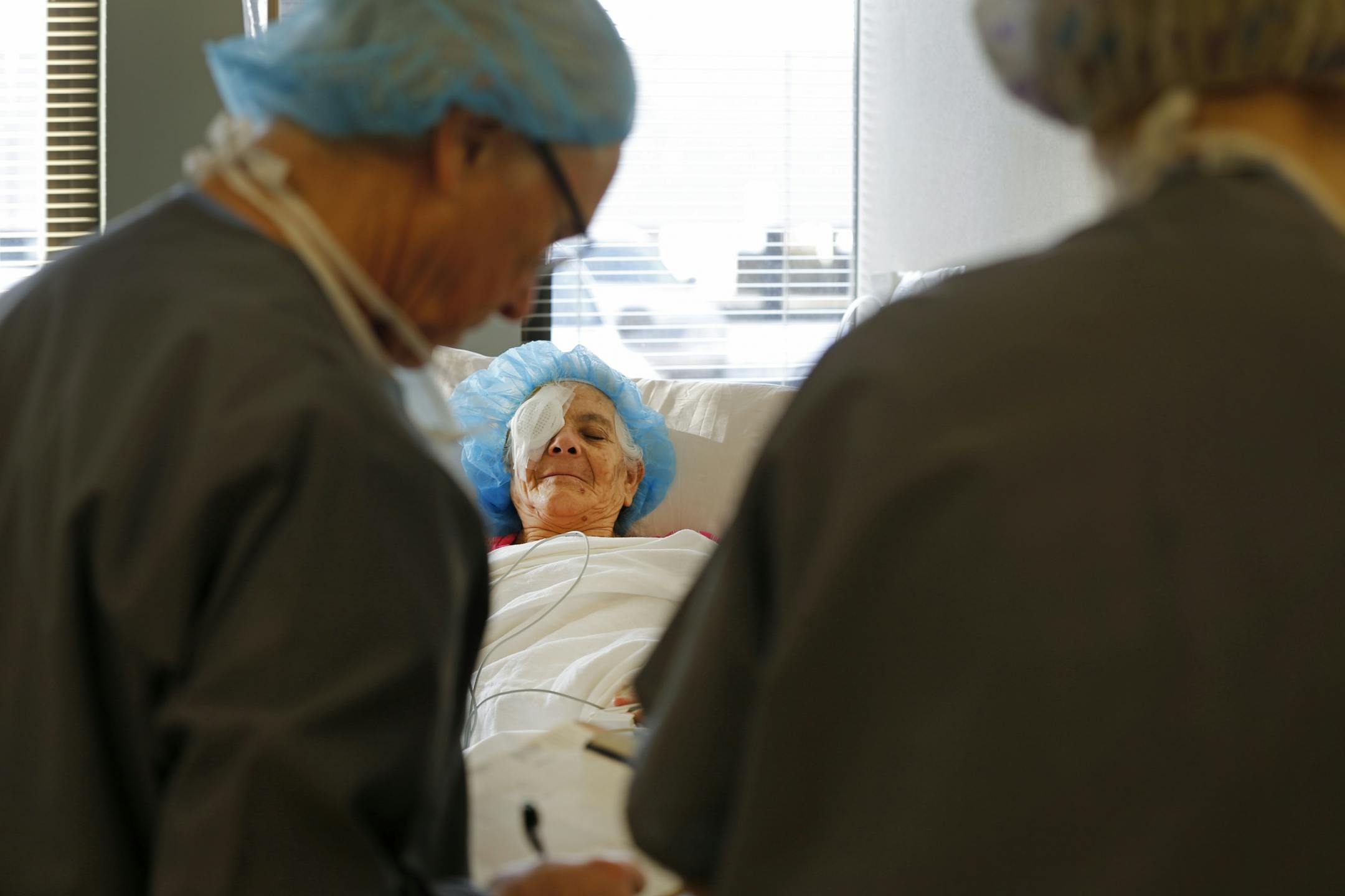 Maria Flores DeCalles rested in the post-operation room after having a cataract removed from her right eye.