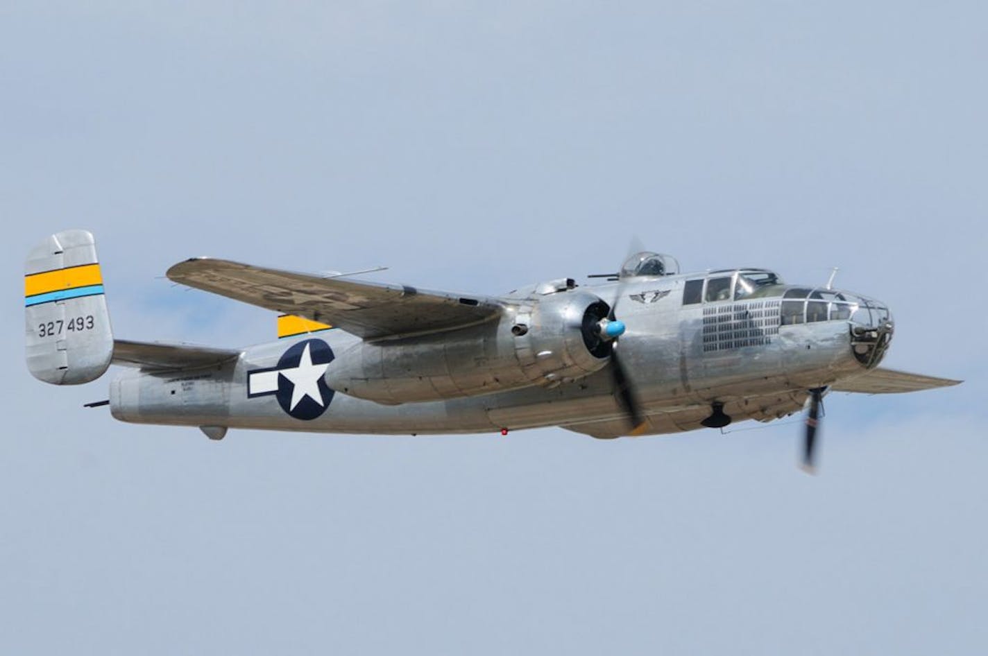 Miss Mitchell shows off her beauty against a clear-blue autumn sky. (Inset) Shown here en route to Amsterdam, Mullaly flew every type of airplane that NWA had, except for the B-757. After a 25-year career, he retired in 2009 as an A-330 captain. Photo by Jerry Goodrich