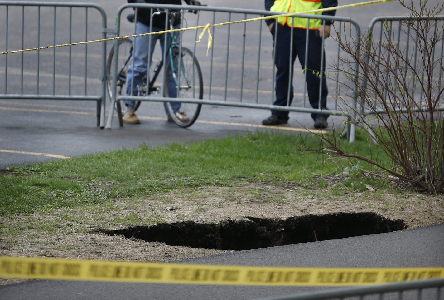 On the bike path of the W. River Parkway near Portland Ave and the Stone Arch Bridge where a sinkhole developed, authorities close traffic as a precaution.] Richard Tsong-Taatarii/rtsong-taatarii@startribune.com