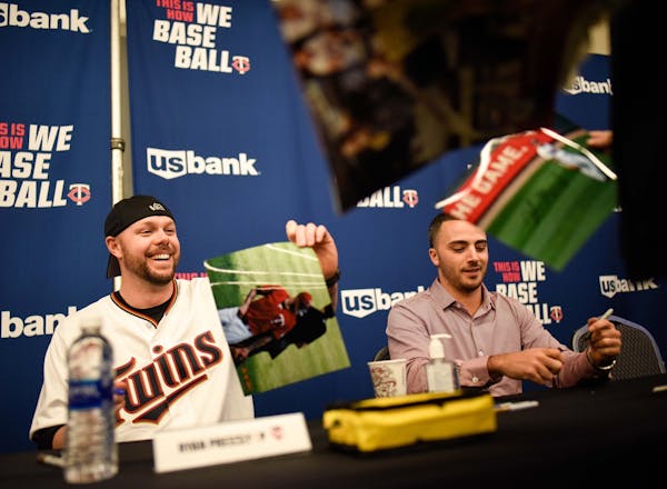Twins pitcher Ryan Pressly, left, and outfielder Zack Granite signed autographs for fans Friday at Twins Fest.
