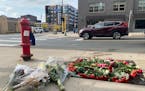 A memorial of flowers marks the area where Autumn Merrick was struck and killed during a rolling gun battle in downtown Minneapolis.