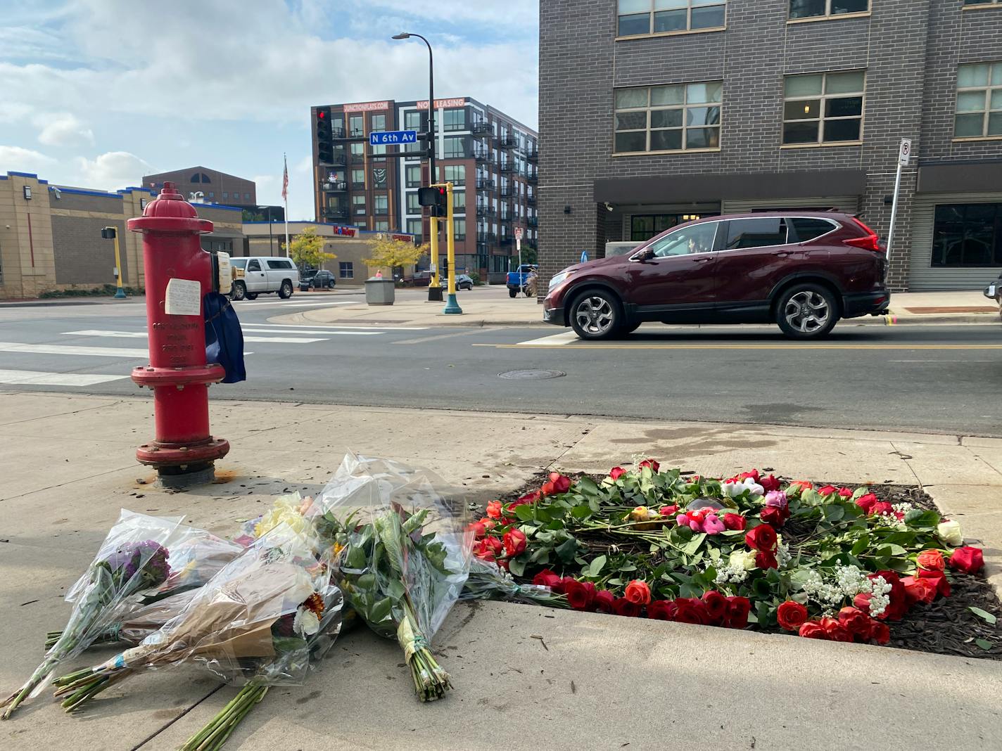 A memorial of flowers marks the area where Autumn Merrick was struck and killed during a rolling gun battle in downtown Minneapolis.