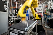 A robot at Graco assembles air hose needle valves at Graco on Feb. 14, 2019, A key manufacturing index slipped into negative territory in Minnesota an