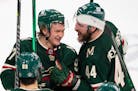 Minnesota Wild left wing Kirill Kaprizov (97) celebrates with left wing Nicolas Deslauriers (44) after defeating the Seattle Kraken 6-3.