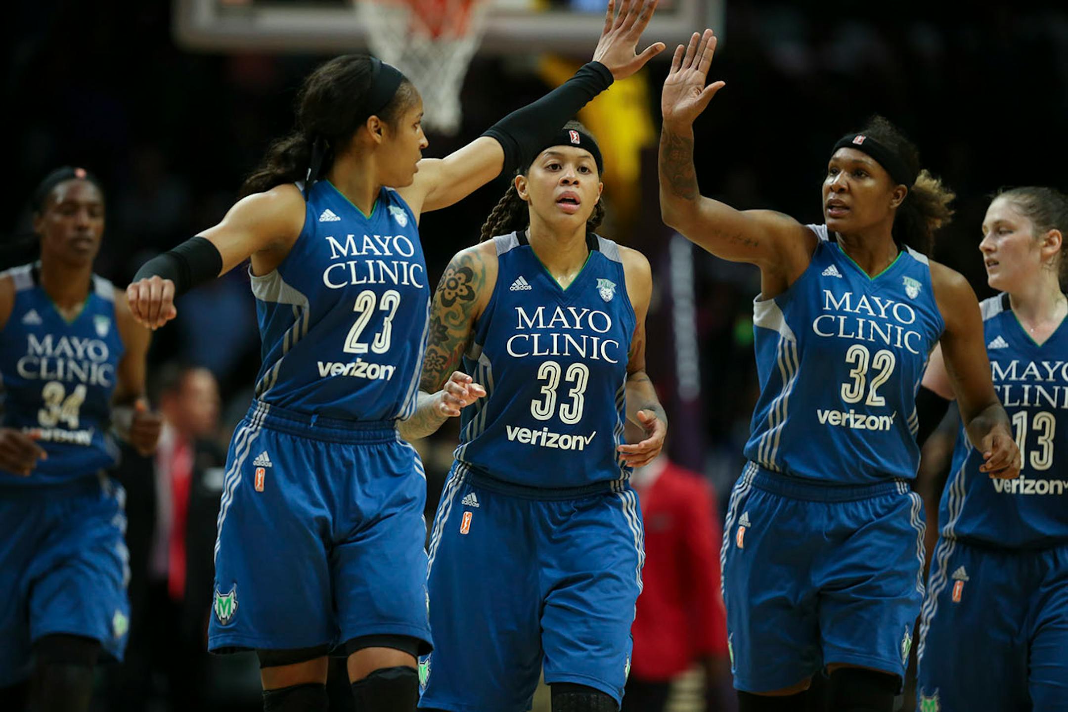 Minnesota Lynx forward Maya Moore (23) and forward Rebekkah Brunson (32) high fived over guard Seimone Augustus (33) as they headed to the bench for a late fourth quarter timeout.
