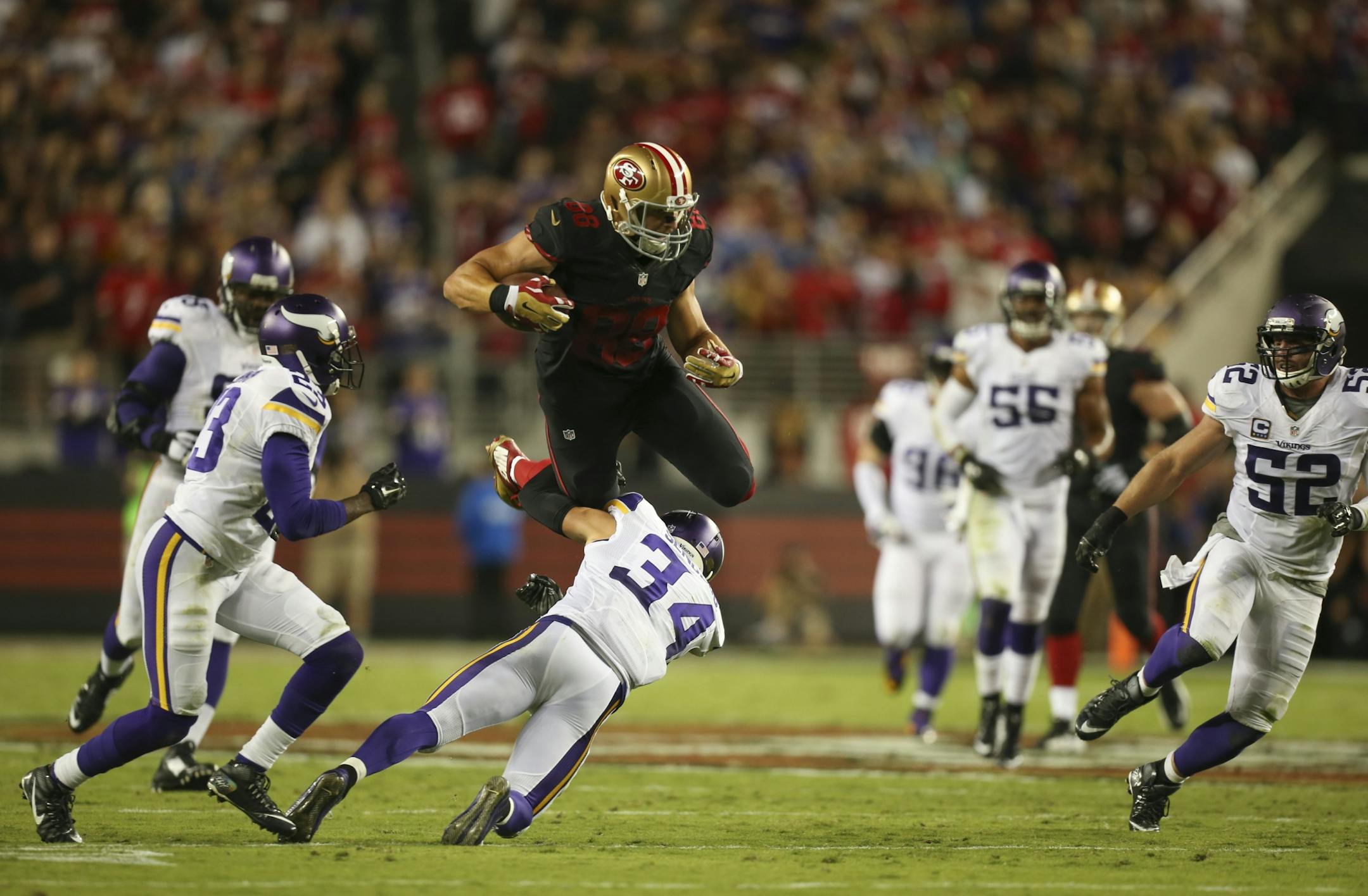 San Francisco 49ers tight end Garrett Celek (88) leapt over Vikings strong safety Andrew Sendejo (34) after catching a short pass for a 20 yaard gain in the second quarter Monday night. San Francisco scored the only touchdown of the half later in the drive.