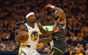 Golden State Warriors forward Jimmy Butler III (10) drives into Minnesota Timberwolves guard Nickeil Alexander-Walker (9) early in Game 3.
