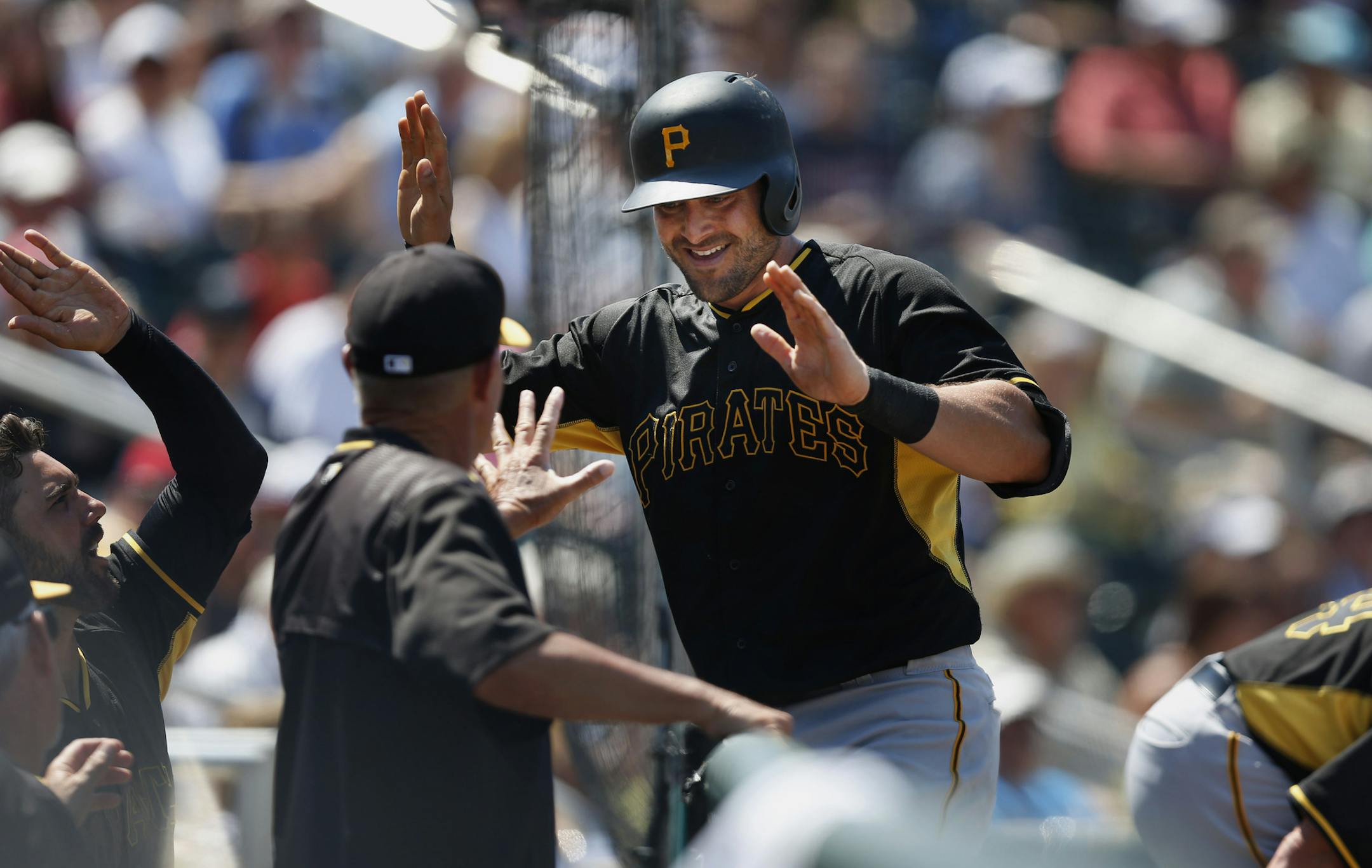 Pittsburgh Pirates baserunner Francisco Cervelli (29) high fives his teammates after hitting a solo home run in the fifth inning during an exhibition spring training baseball game against the Minnesota Twins, Friday, March 20, 2015, in Fort Myers, Fla. (AP Photo/Brynn Anderson)