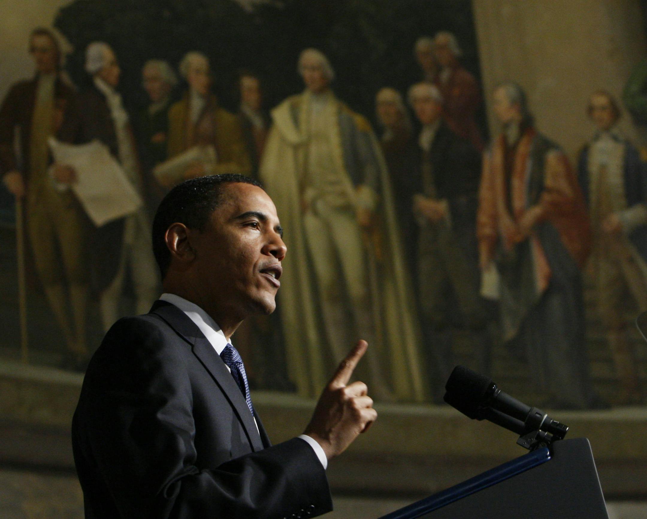 ** RE-CROPPED VERSION OF WHCD103 **President Barack Obama delivers an address on national security, terrorism, and the closing of Guantanamo Bay prison, Thursday, May 21, 2009, at the National Archives in Washington. Above is a mural painted by Barry Faulkner in 1936 of the Constitution Convention depicting James Madison delivering the final draft of the Constitution to George Washington. (AP Photo/Charles Dharapak)