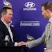 Minnesota Vikings new quarterback Kirk Cousins, right, is welcomed to the podium by head coach Mike Zimmer after signing in 2018.