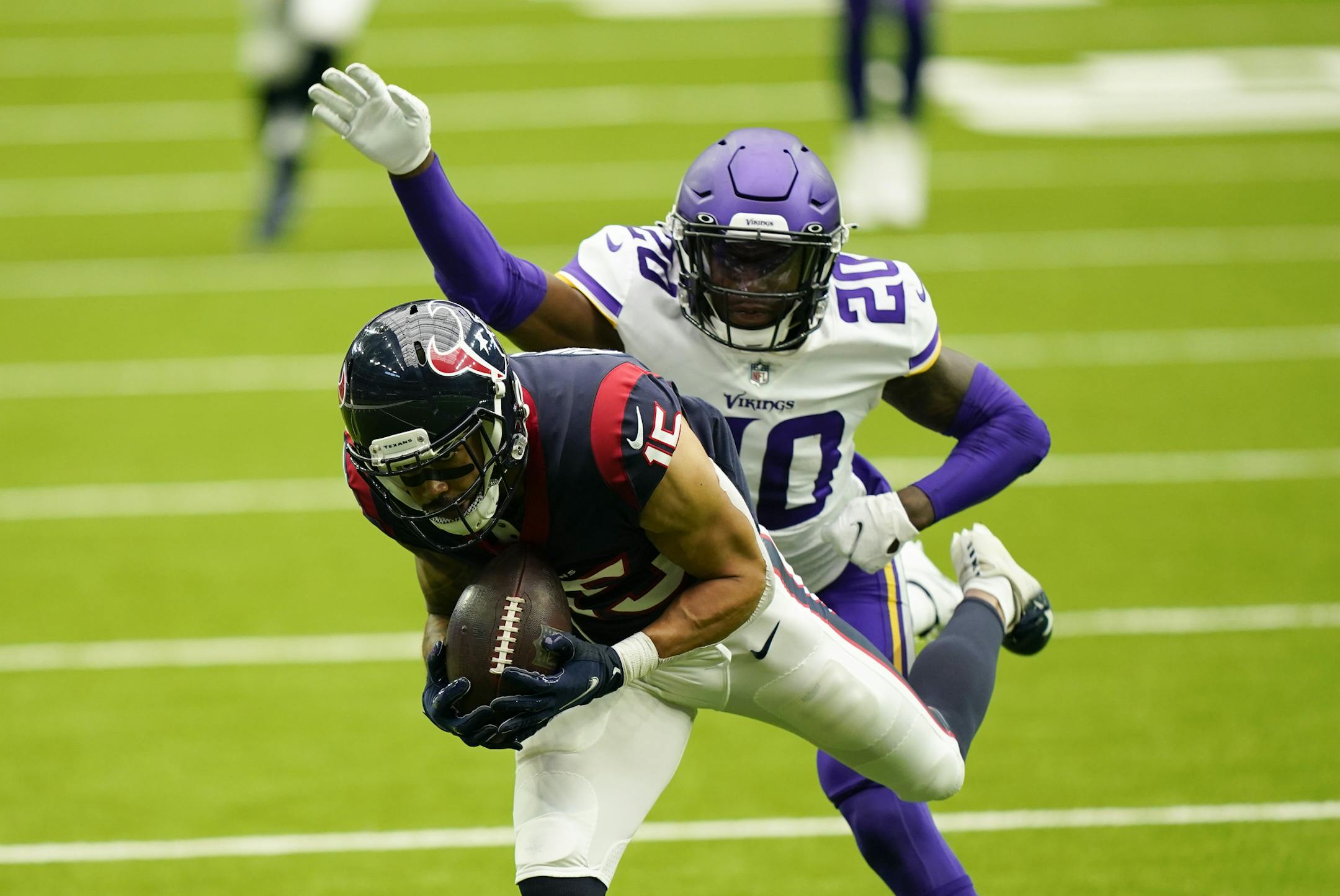 Houston Texans wide receiver Will Fuller catches a pass ahead of Minnesota Vikings cornerback Jeff Gladney (20) during the second half of an NFL football game Sunday, Oct. 4, 2020, in Houston. (AP Photo/David J. Phillip)
