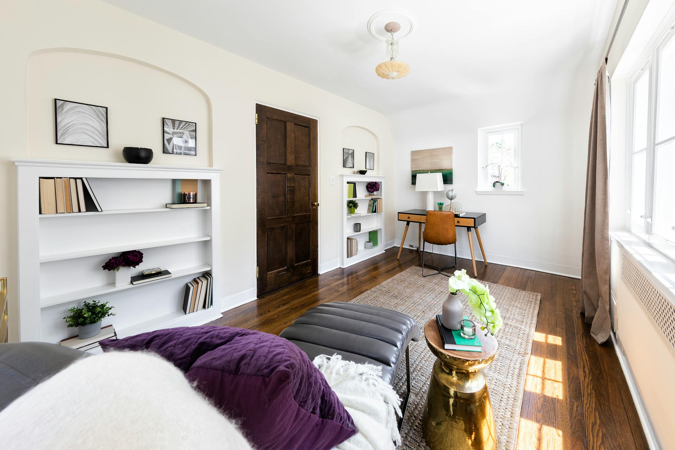 A wood desk is paired with a leather chaise to blend with the architectural feel of this office space. (Handout/TNS)