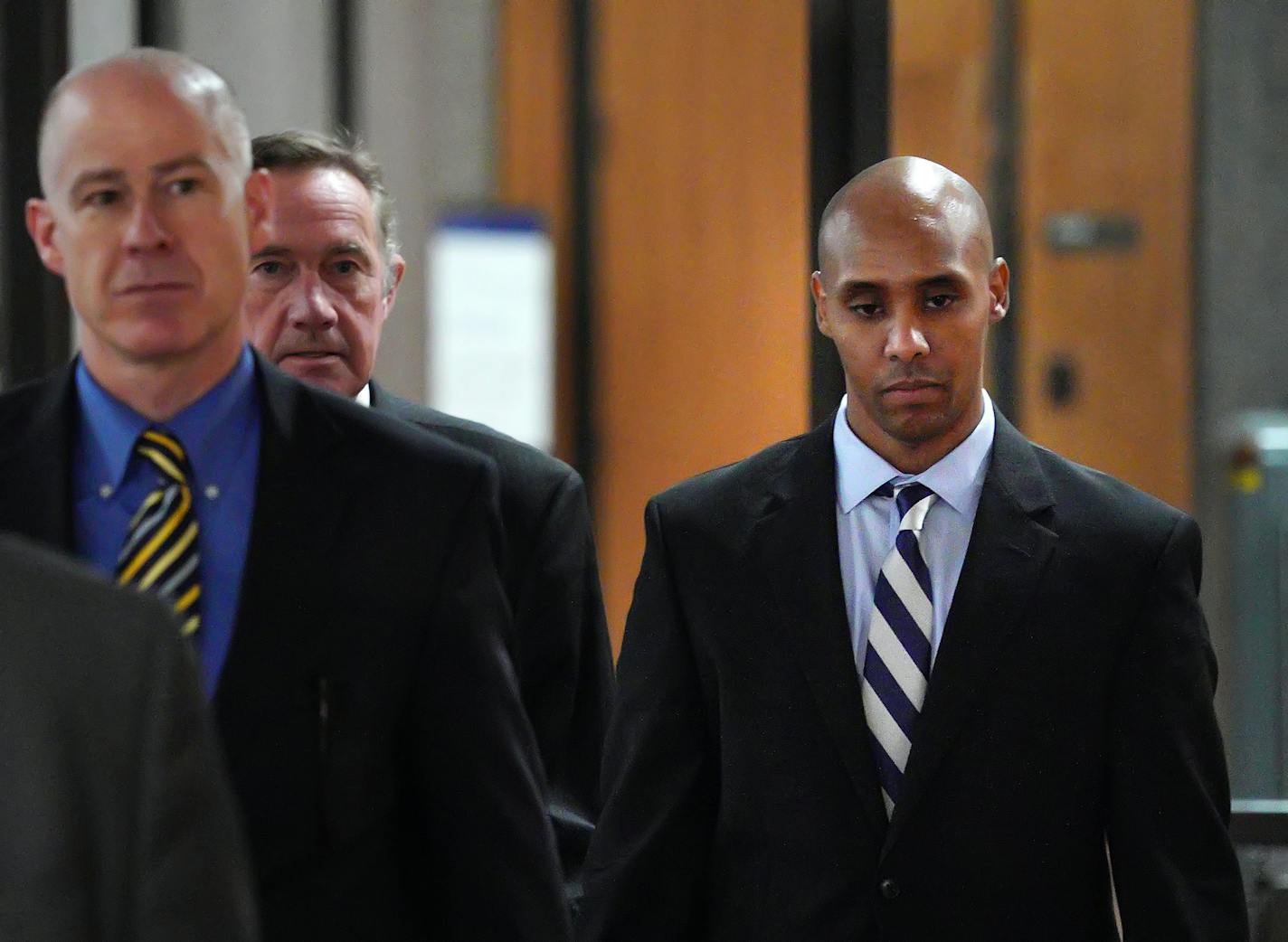 Ex-Minneapolis police officer Mohamed Noor, right, with attorneys Peter Wold, center, and Thomas Plunkett, left walk out of the the Hennepin County Government Center on April 25.