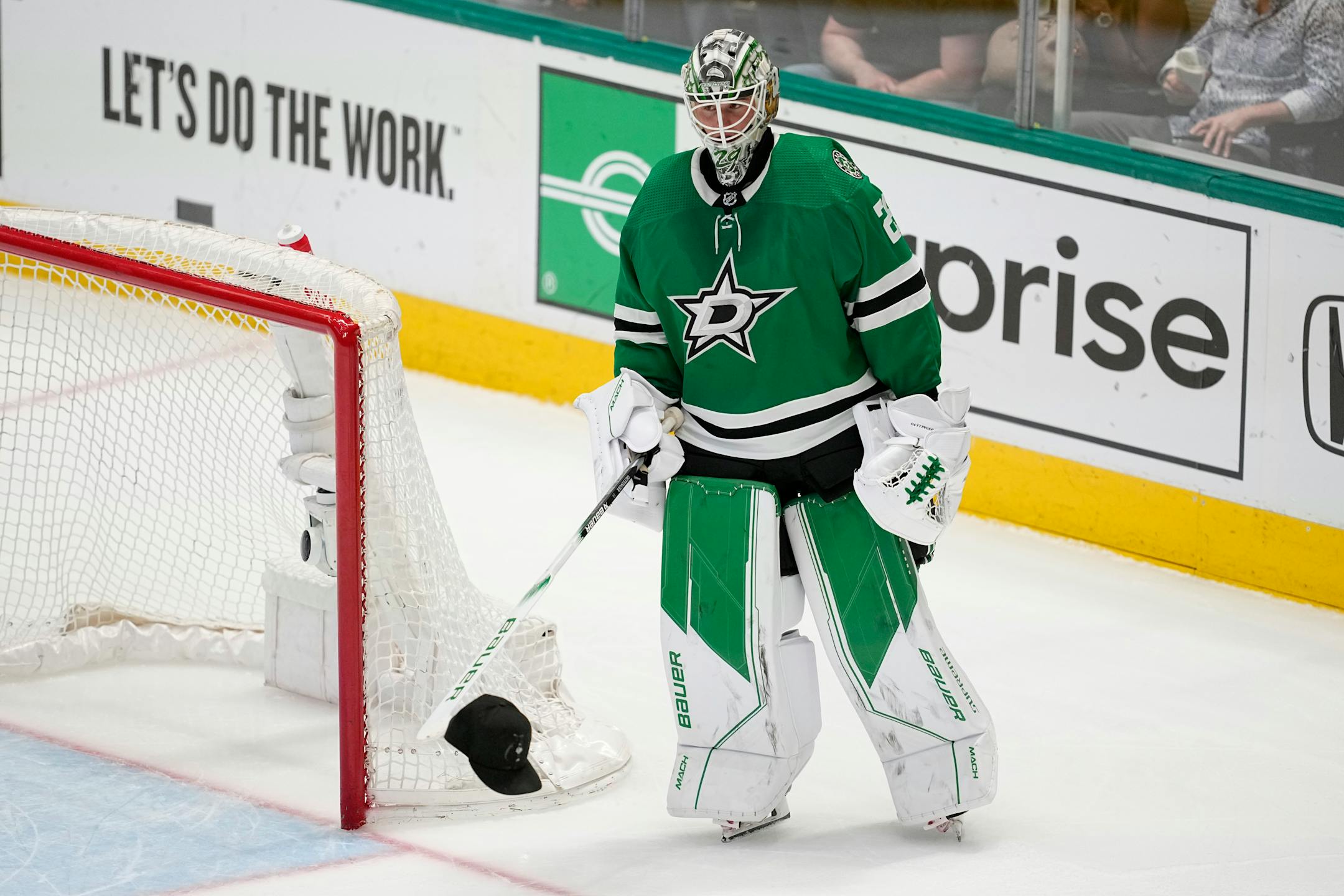 Dallas Stars goaltender Jake Oettinger (29) carries a cap on the end of his stick that was tossed onto the ice after Roope Hintz scored his third goal of the game in the third period of Game 2.