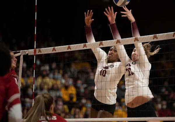 Minnesota Gophers Stephanie Samedy(10) and Katie Myers(23) attempt to block at the net against the Wisconsin Badgers in Minneapolis, Minn., on Sunday,