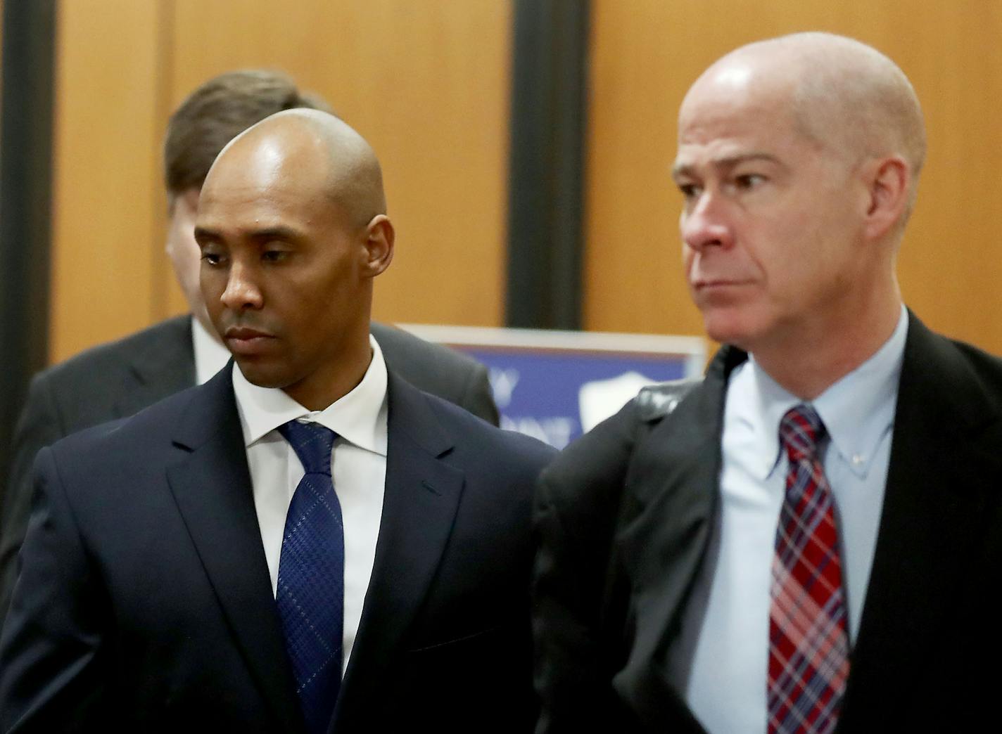 Former Minneapolis police officer Mohamed Noor, center, is accompanied by his attorneys Peter Wold, not pictured, and Thomas Plunkett, right, as he walks towards the Hennepin County Government Center for opening arguments of his trial Tuesday, April 9, 2019, in Minneapolis, MN.] DAVID JOLES &#x2022;david.joles@startribune.com Opening arguments scheduled to begin in the trial of former Minneapolis police officer Mohamed Noor in the shooting death of Justine Ruszczyk Damond.