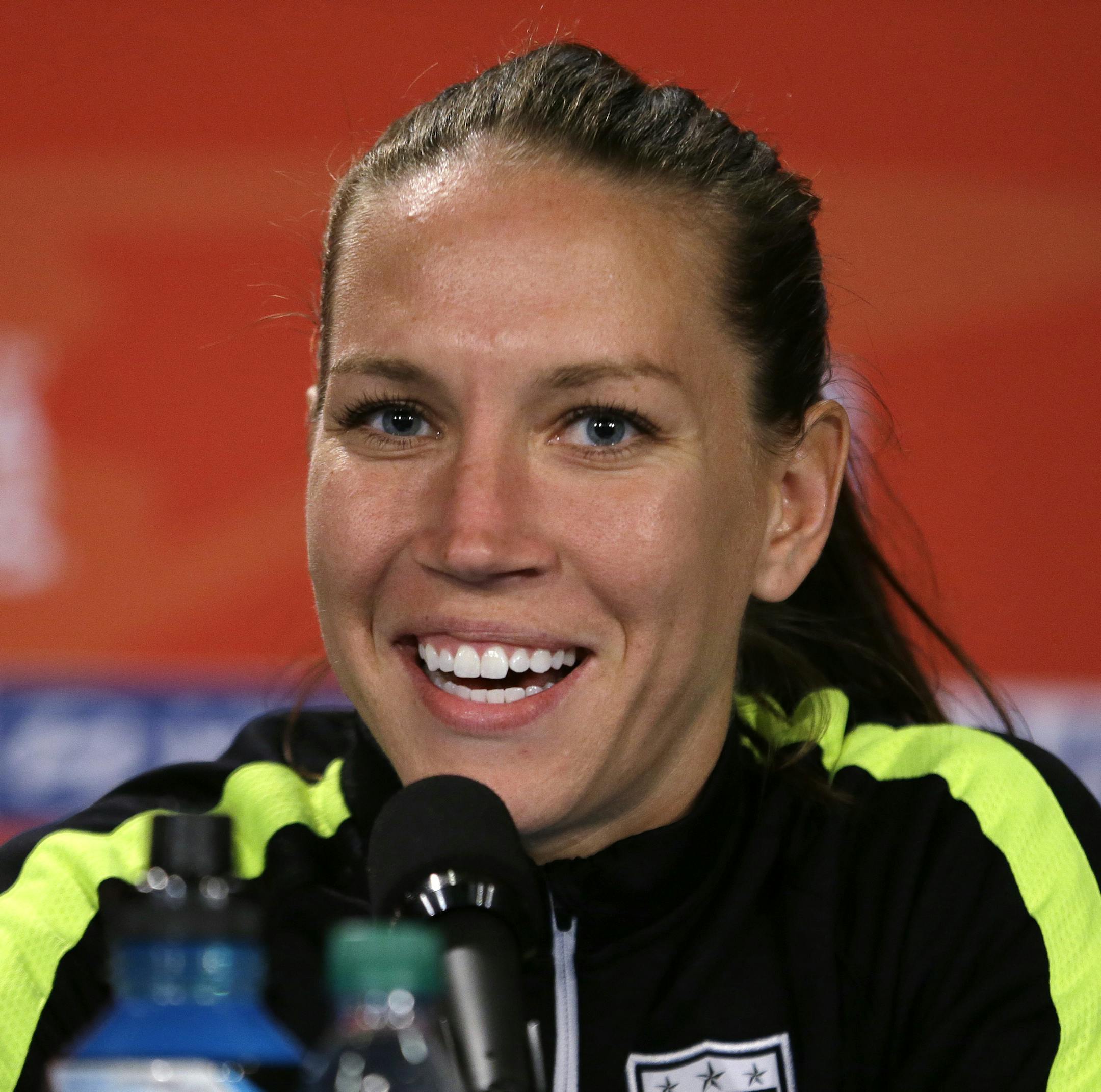 FILE - In this July 4, 2015 file photo, U.S. midfielder Lauren Holiday speaks during a news conference for the Women's World Cup soccer final in Vancouver, British Columbia, Canada. The New Orleans Pelicans say guard Jrue Holiday will be taking indefinite leave to care for his wife, Lauren Holiday, who is pregnant and needs brain surgery. "We are all praying for a healthy delivery of their first child and a successful surgery for Lauren," Pelicans general manager Dell Demps said in a prepared st