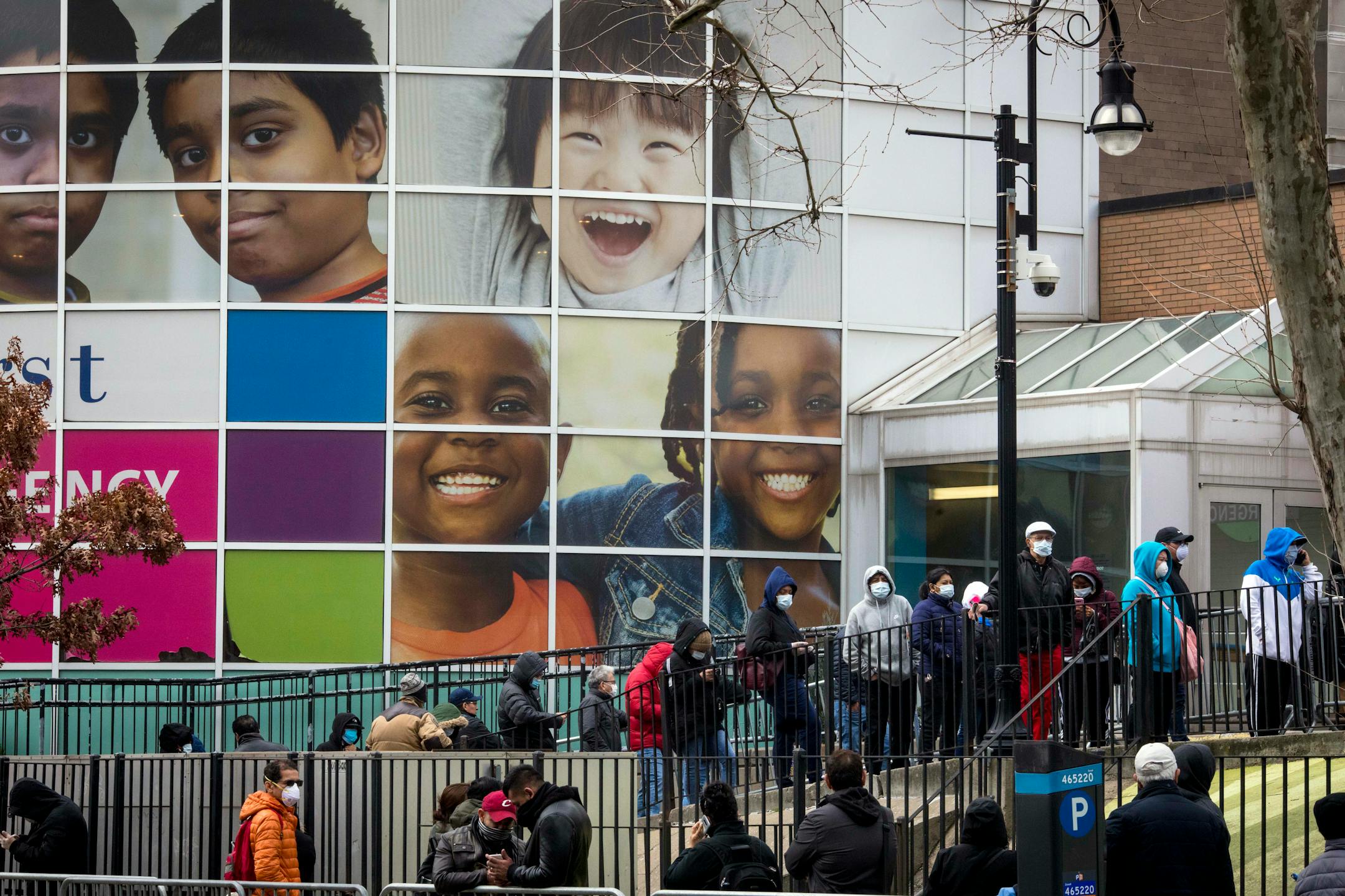 America has a fractured culture, John Kass says. With that in mind, will we be able to come together during this crisis? Above, a line of people wait to be tested for COVID-19 outside of Elmhurst Hospital Center in the Queens borough of New York on Friday.