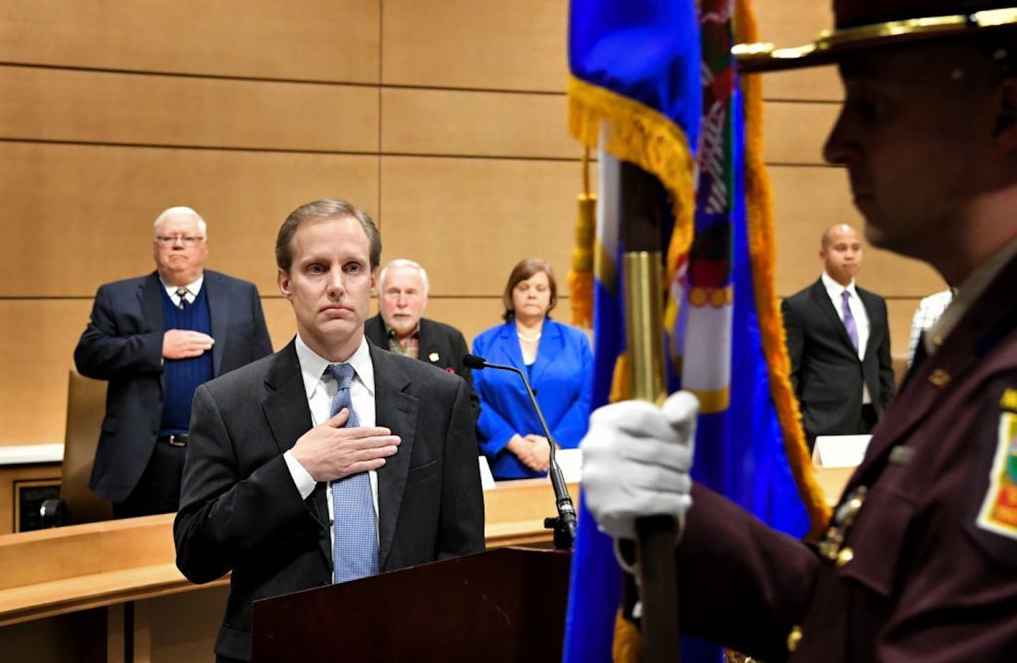 Secretary of State Steve Simon held his hand over his heart as the Minnesota State Patrol Honor Guard posted the colors. Muhammad Abdurrahman, who voted for Sen. Bernie Sandersis on the right.