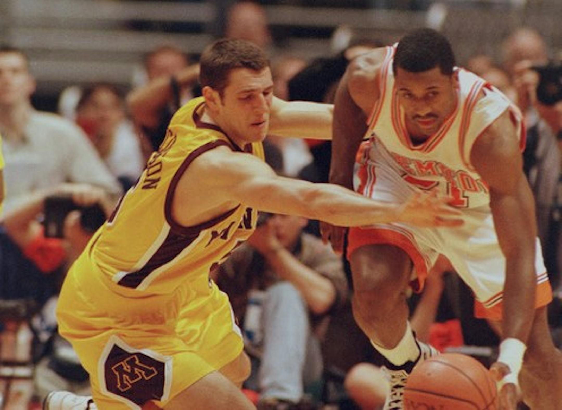 -- Sam Jacobson left of Minnesota tries to steal the ball from Greg Buckner of Clemson during the 2nd half of NCAA action.
