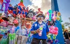 Julio Garcia Sanchez blows bubbles at fairgoers as they pass his Dandy Souvenirs stand, one of 8 locations at the Minnesota State Fair. ] GLEN STUBBE 