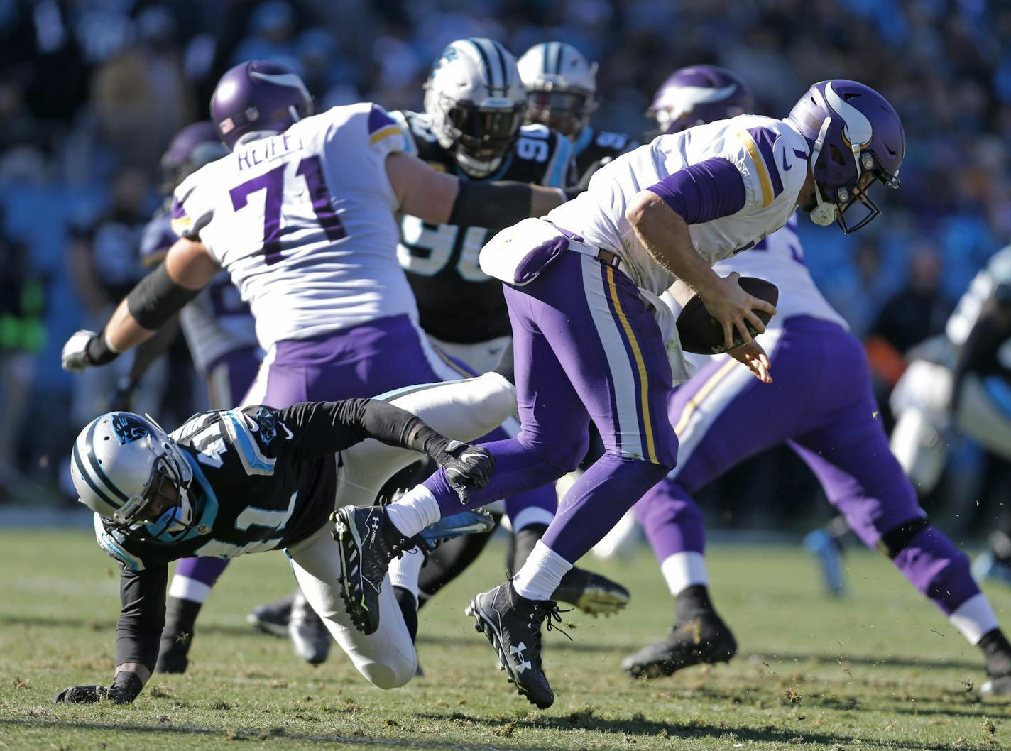 Minnesota Vikings' Case Keenum (7) escapes the tackle of Carolina Panthers' Captain Munnerlyn (41) during the first half of an NFL football game in Charlotte, N.C., Sunday, Dec. 10, 2017. (AP Photo/Bob Leverone)