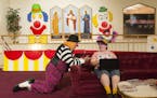 Fred "Ozzie" Bausch, a Mooseburger instructor of 12 years, chatted with Bonnie-Jean Brown about collectible clown figurines late Tuesday night.