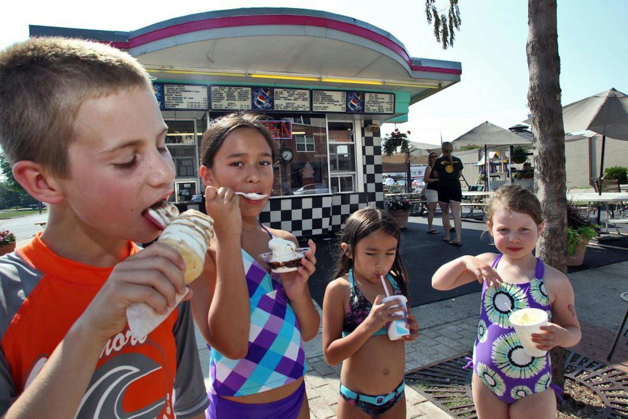 Dairy Delite is a seasonal ice cream / burgers / fries stand that operates in downtown Lakeville and serves as a destination point for summer fun. Tyler DeWaard, 9, Isabela Munroz, 10, Gabby Munroz, 6, Alyssa DeWaard, 6 - all of Lakeville - left to right, ate ice cream treats in front of the stand.(MARLIN LEVISON/STARTRIBUNE(mlevison@startribune.com
