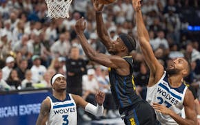 Warriors forward Jimmy Butler was fouled by Timberwolves center Rudy Gobert on Thursday night at Target Center.