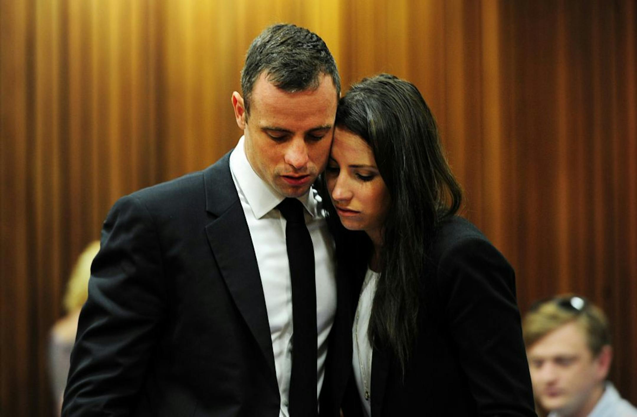 Oscar Pistorius hugs his sister Aimee, right, in court in Pretoria, South Africa, Wednesday, March 19, 2014.
