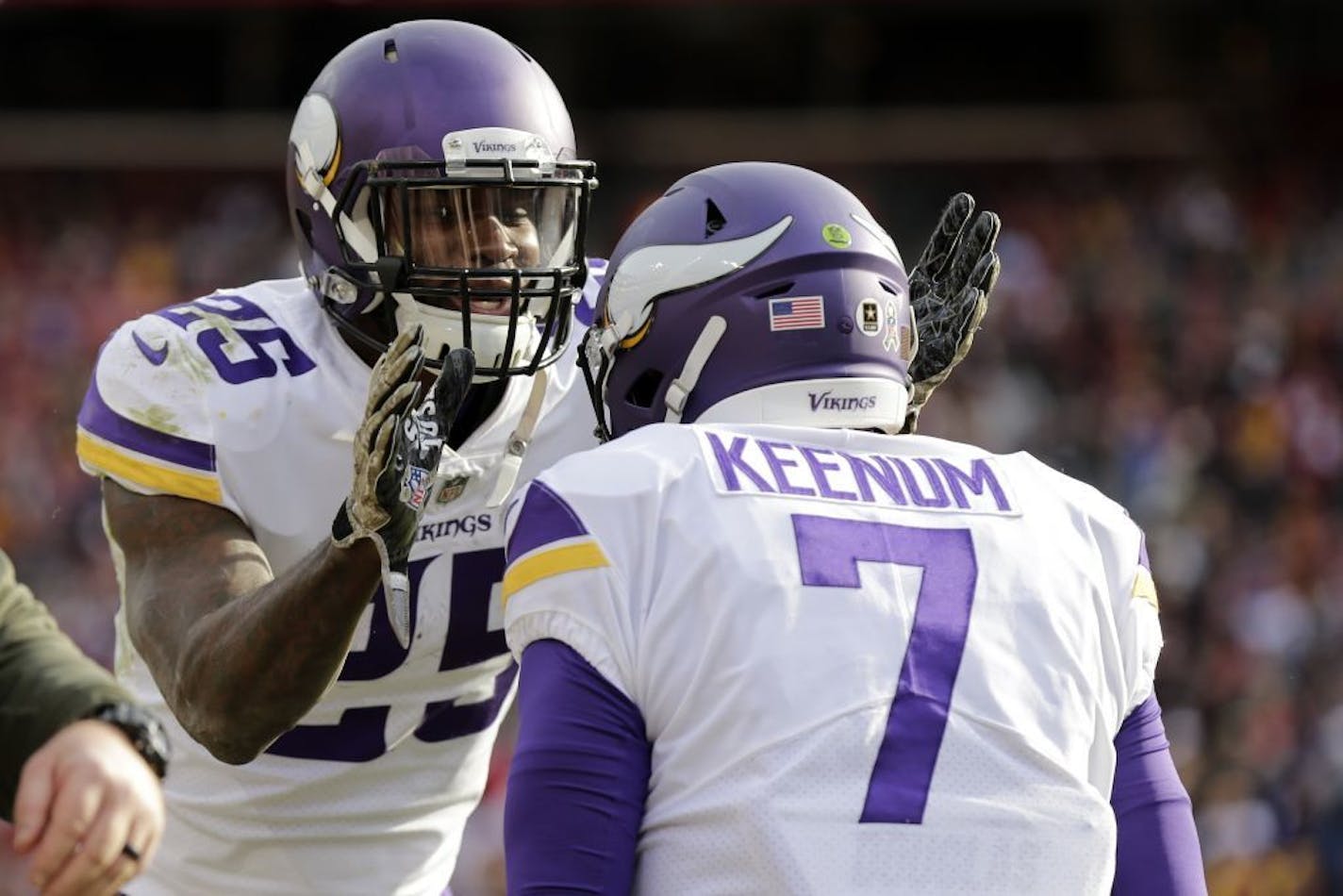 Minnesota Vikings running back Latavius Murray (25) and quarterback Case Keenum (7) celebrate a touchdown during an NFL football game against the Washington Redskins, Sunday, Nov. 12, 2017, in Landover, Md.