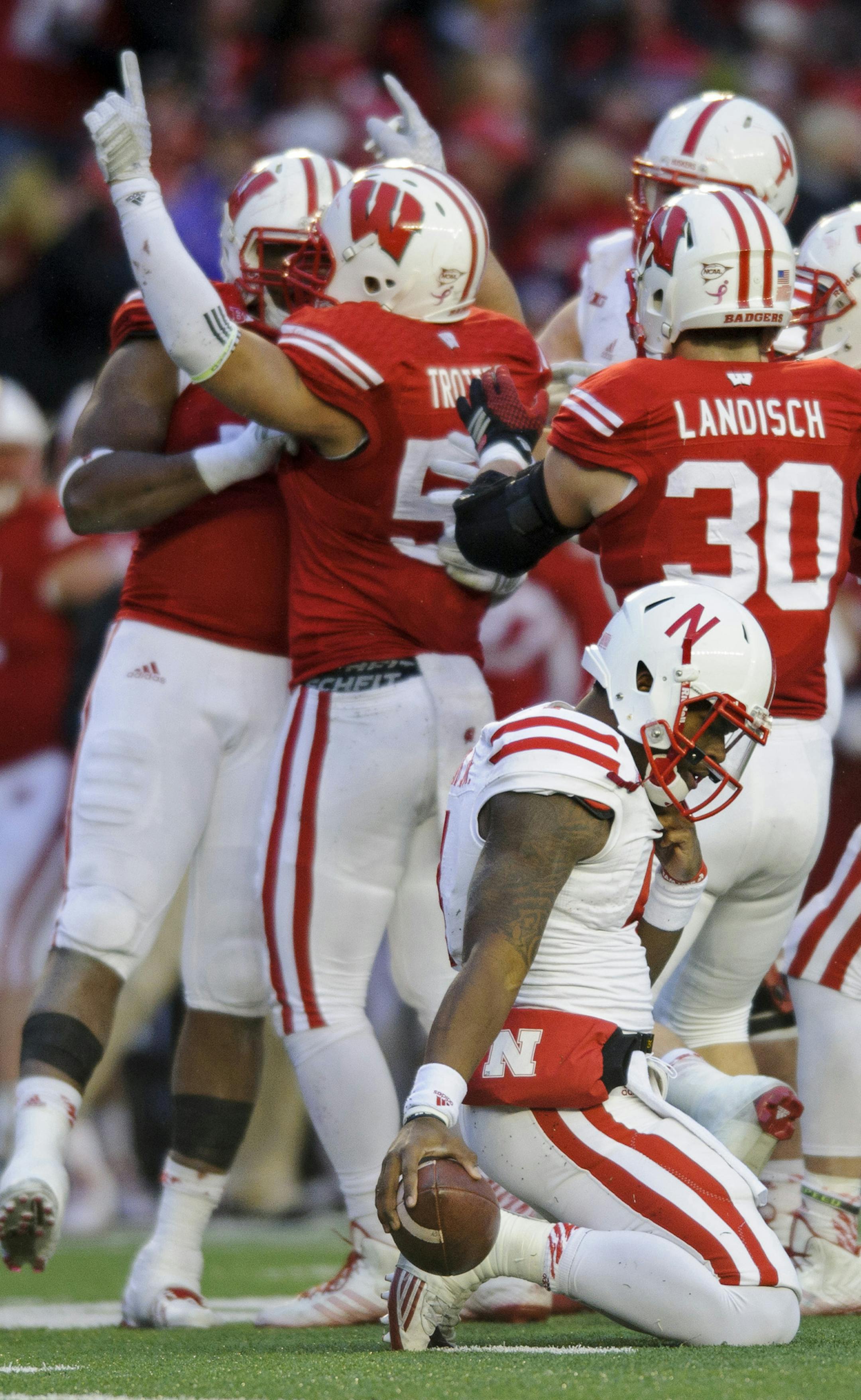 Nebraska quarterback Tommy Armstrong Jr. (4) reacts to getting sacked by Wisconsin linebacker Marcus Trotter (59) during the second quarter of an NCAA college football game Saturday, Nov. 15, 2014, in Madison, Wis. Wisconsin won 59-24. (AP Photo/The Journal-Star, Matt Ryerson)