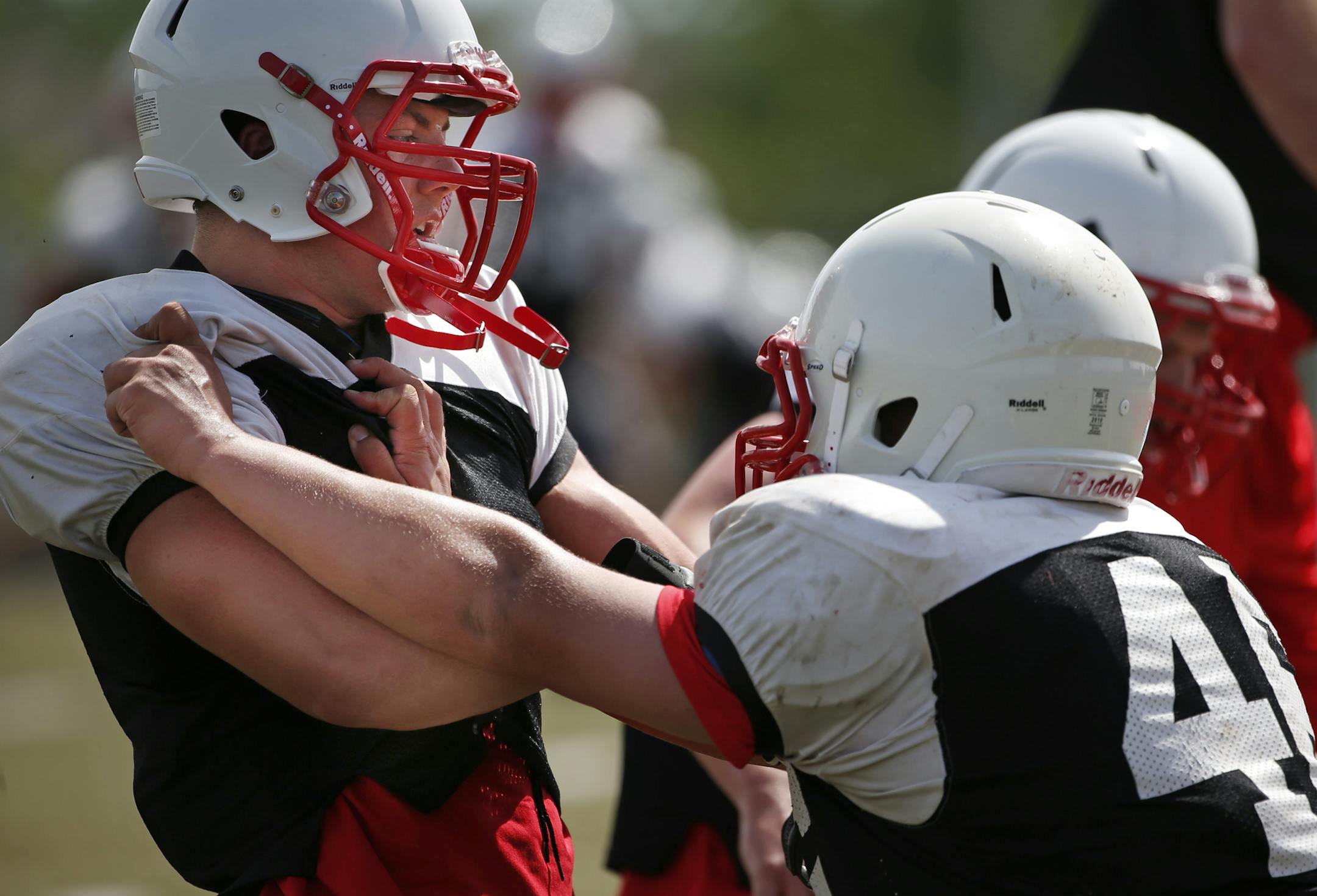 At Lakeville North, any football drill contact is limited to the push/pull variety as evidenced by the drills between Ryan Bissonett (1) and Jeremy Ziemer (46).