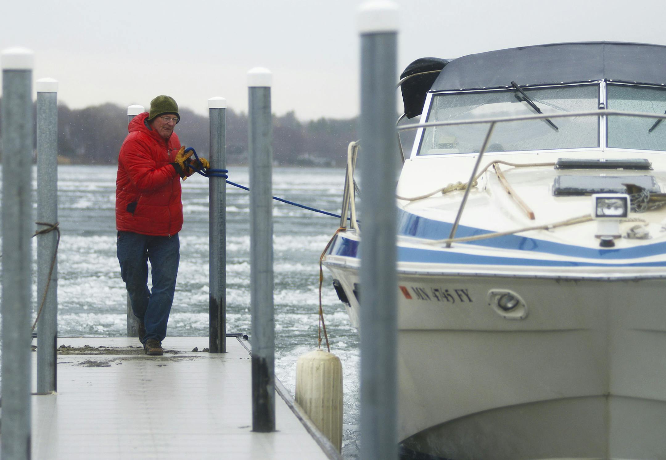 North Shore Marina owner Richie Anderson ropes in his boat after going out on Lake Minnetonka in Wayzata, Minn. on Wednesday. Anderson went out on his boat to help crush up the unbroken ice and prevent it from crashing into the docks and piling up. "I think this is the last of it," Anderson said. ] (AMANDA SNYDER/ Special to the Star Tribune) ORG XMIT: MIN1404231520560407
