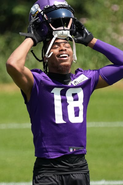 Minnesota Vikings wide receiver Justin Jefferson (18) adjusts his helmet on the first day of the Vikings mandatory minicamp Tuesday, June 13, 2023 at 