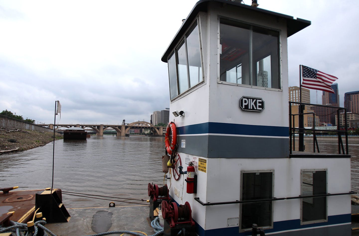 The Pike is the tug boat the five men appropriated in order to rescue the individual from the Mississippi River. In the background, the bridge that the individual jumped from, the Roberts Street Bridge, can be seen. ] ALEX KORMANN &#x2022; alex.kormann@startribune.com On May 2, 2018, Beasley Baker, an Upper River Services employee, spotted a man jump from the Robert Street Bridge in an attempted suicide. Baker watched the man continue to float down the Mississippi River. He, along with four othe