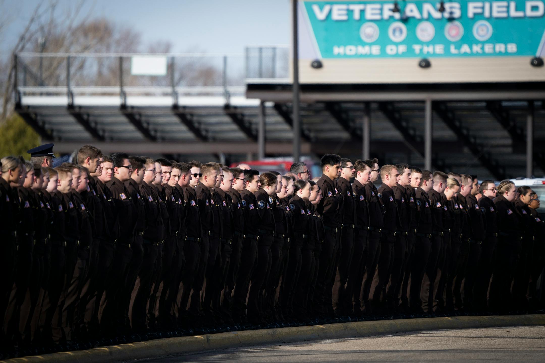 Alexandria law enforcement students line up across the street from the visitation and funeral of Pope County deputy Josh Owen.
