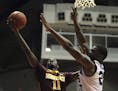Minnesota guard Carlos Morris, left, goes to the basket against Missouri St. forward Jordan Martin during the Puerto Rico Tip-Off college basketball t
