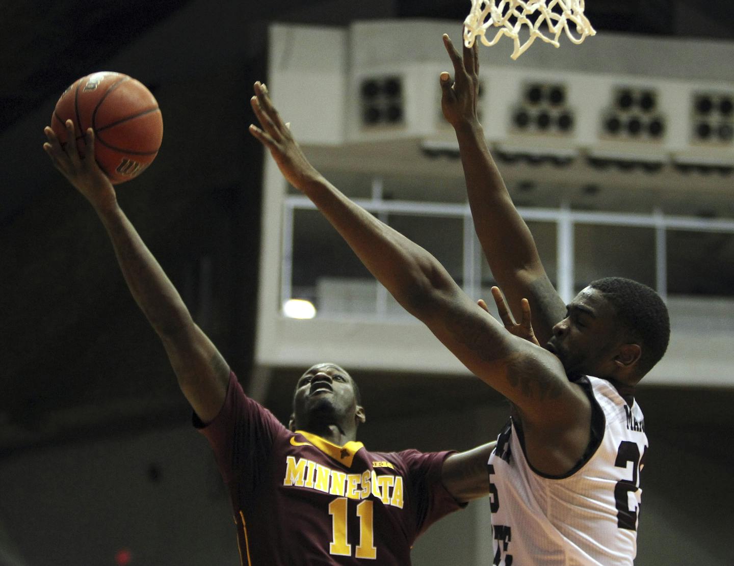 Minnesota guard Carlos Morris, left, goes to the basket against Missouri St. forward Jordan Martin during the Puerto Rico Tip-Off college basketball tournament in San Juan, Friday, Nov. 20, 2015. (AP Photo/Ricardo Arduengo)