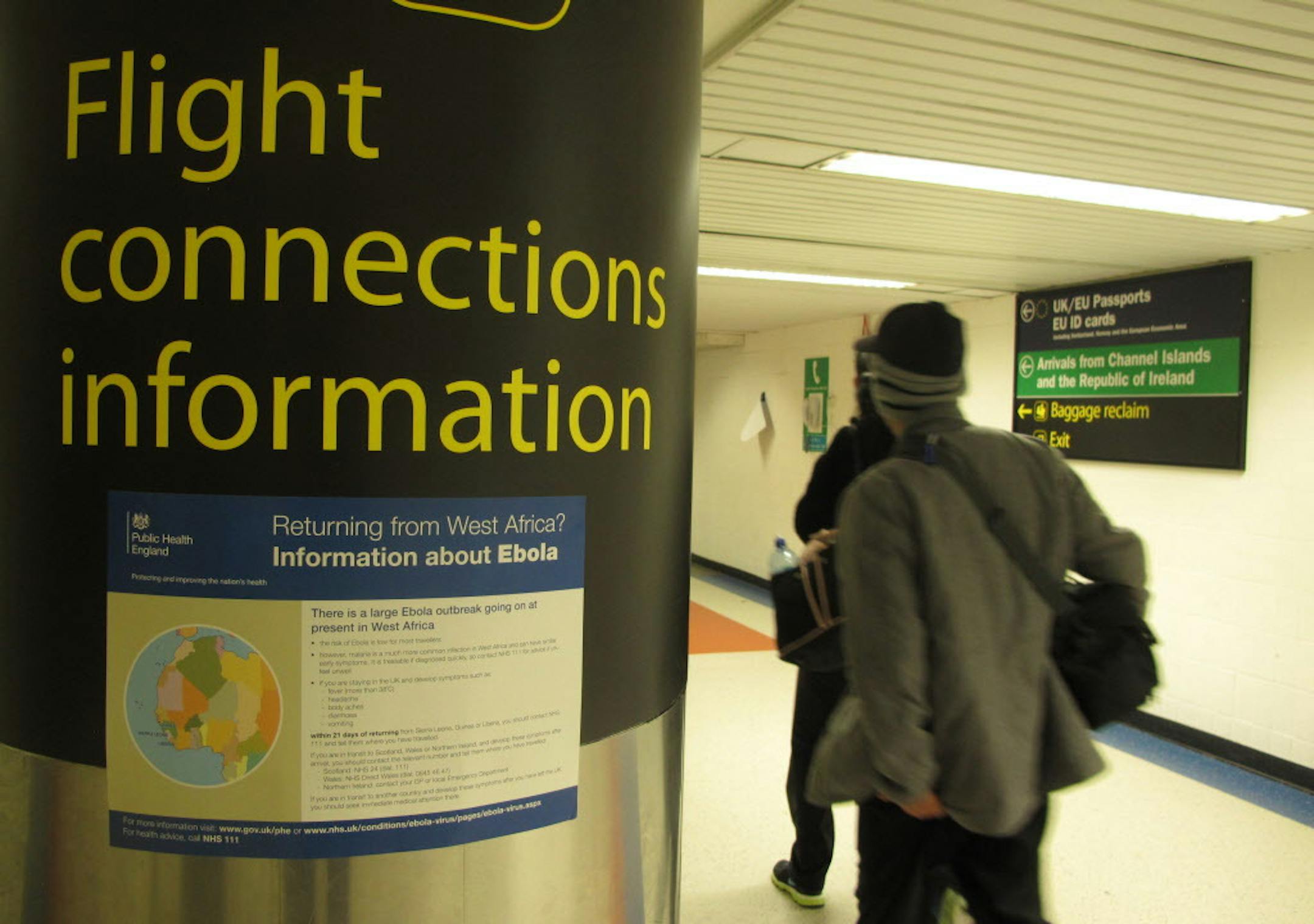 A passenger passes an Ebola warning sign in London's Gatwick Airport, Tuesday, Oct. 21, 2014. A new study published in the Lancet medical journal has found that more cases of the deadly Ebola virus will inevitably be exported on flights out of Guinea, Liberia and Sierra Leone, but screening at airports in those three West African countries has stopped the export of an estimated three cases per month. The report says the countries most at risk of getting Ebola cases imported on flights are neighb