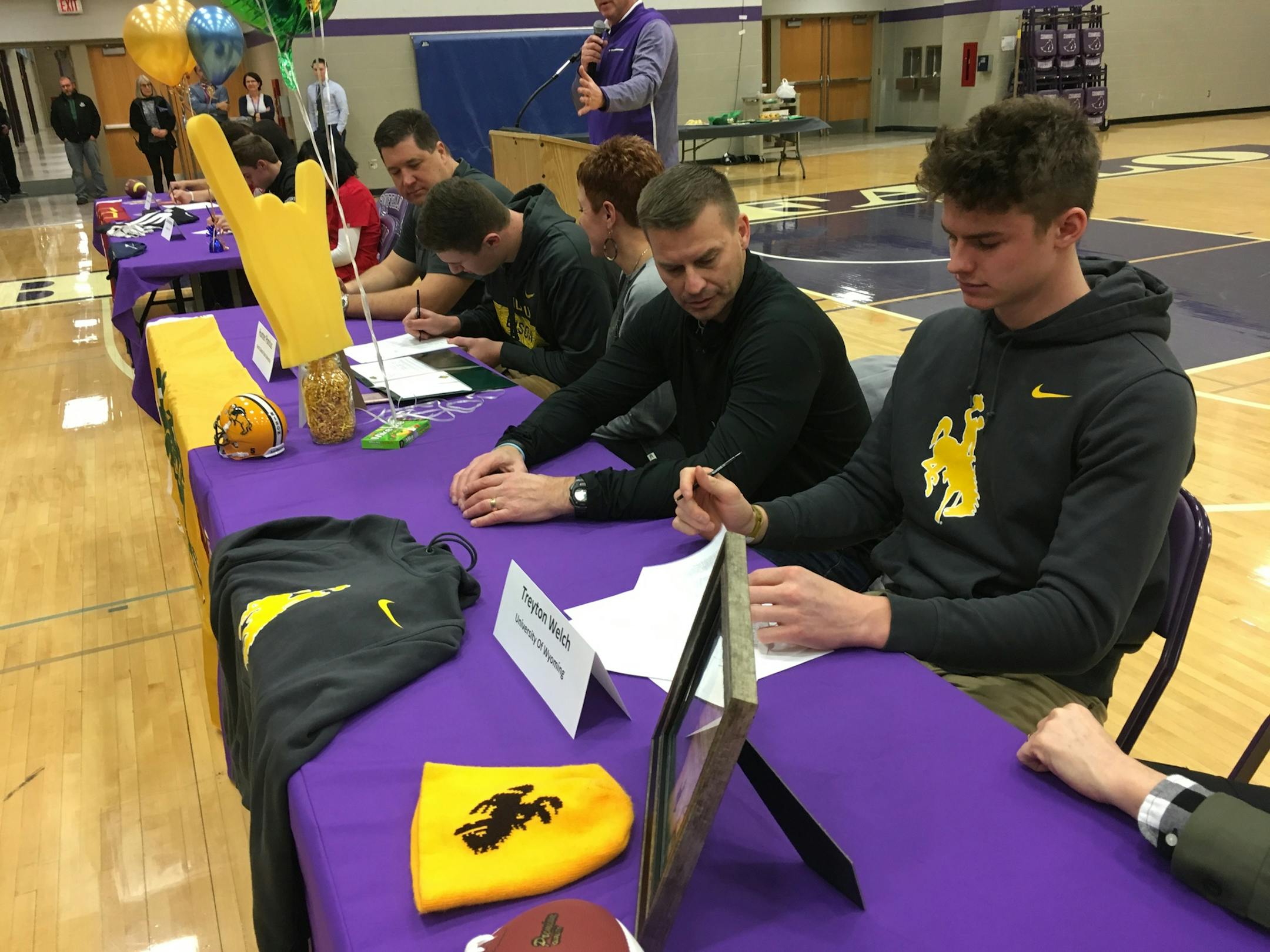 With his father, Vince, seated next to him, wide receiver Treyton Welch of Buffalo High School signed a national letter of intent to play football for Wyoming. Photo by Jim Paulsen.