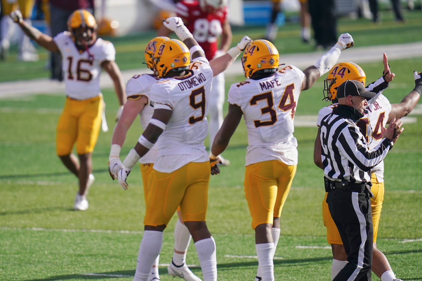 Minnesota players celebrate after defensive lineman Boye Mafe (34) sacked Nebraska quarterback Adrian Martinez during the second half of an NCAA college football game in Lincoln, Neb., Saturday, Dec. 12, 2020. Minnesota won 24-17. (AP Photo/Nati Harnik)