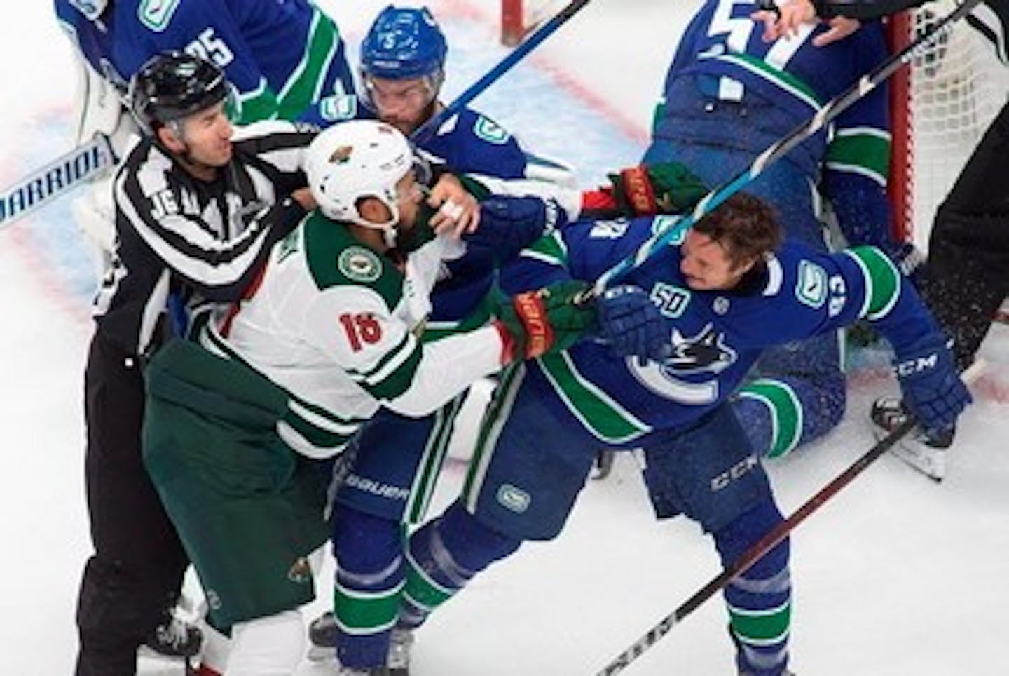 Vancouver Canucks' Jay Beagle (83) battles against Minnesota Wild's Jordan Greenway (18) during the first period of an NHL hockey playoff game Sunday, Aug. 2, 2020, in Edmonton, Alberta. (Codie McLachlan/The Canadian Press via AP)