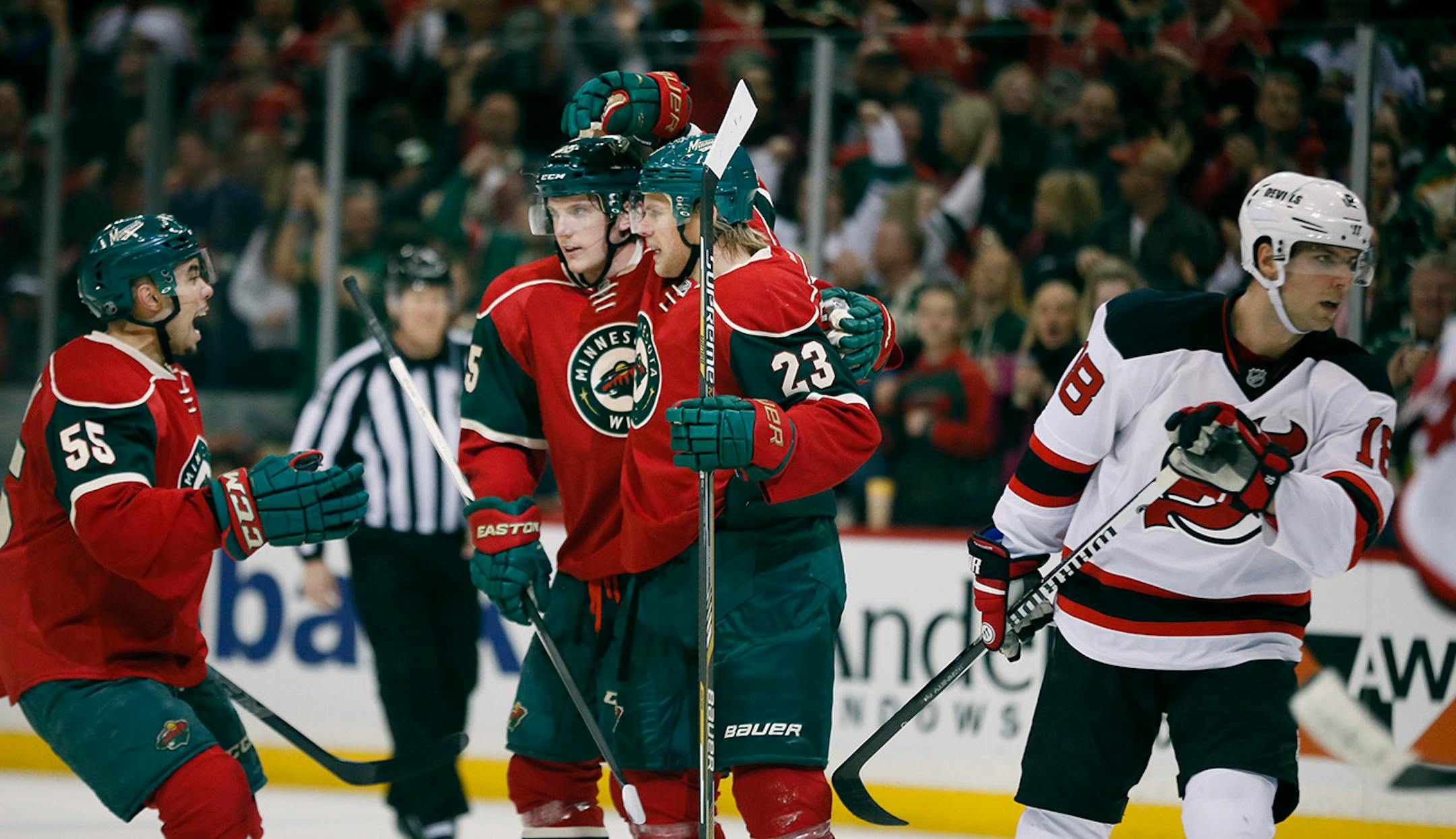 Minnesota Wild left wing Sean Bergenheim (23) celebrated his first period goal with Jonas Brodin (25) and Matt Dumba (55).