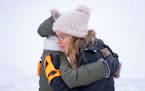 Nancy Musser embraces her daughter-in-law, Julia Musser, as they search for Nancy's son, George Musser, Sunday, Dec. 25, 2022 in Stillwater, Minn. Geo
