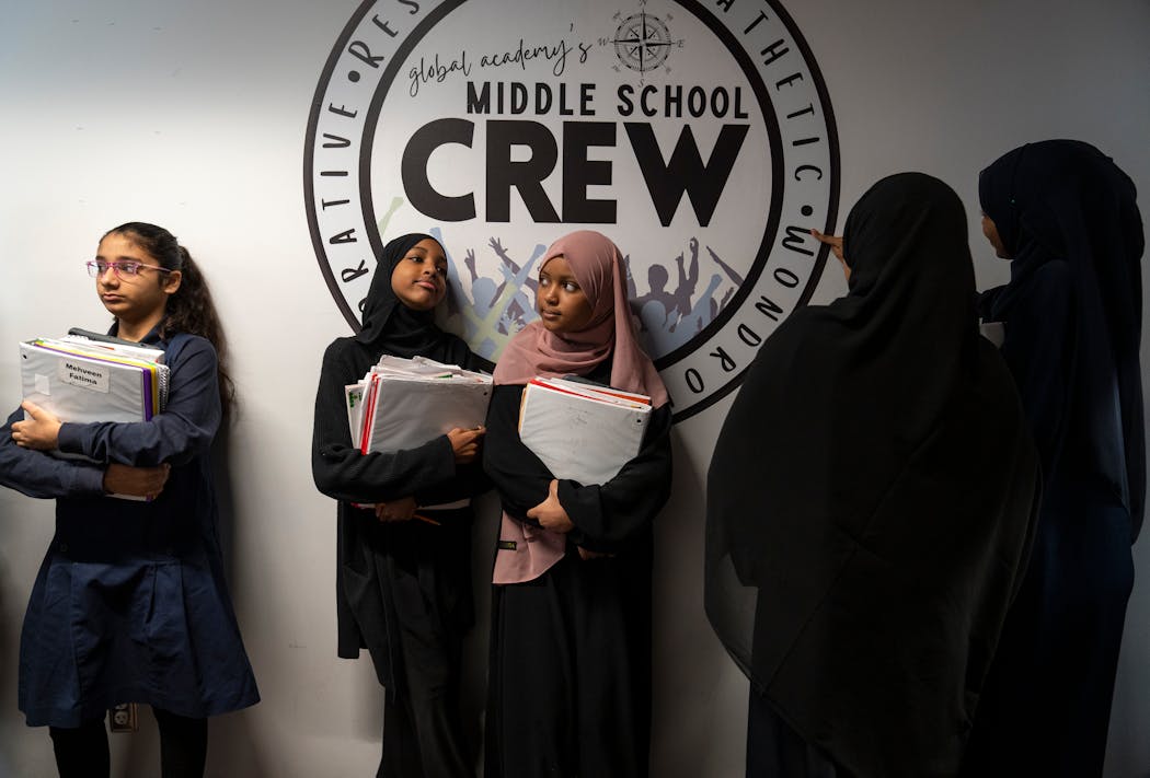 Middle-schoolers transitioned to their next class at Global Academy in New Brighton on Tuesday. From left are seventh-graders Mehveen Fatima, Jamila Hashi and Hanan Ahmed.