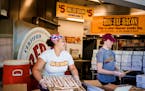 On the Minnesota State Fairgrounds in Falcon Heights, MN on May 26, 2021 Alexana Lofton and Megan Hare get the bacon ready for the big opening tomorro