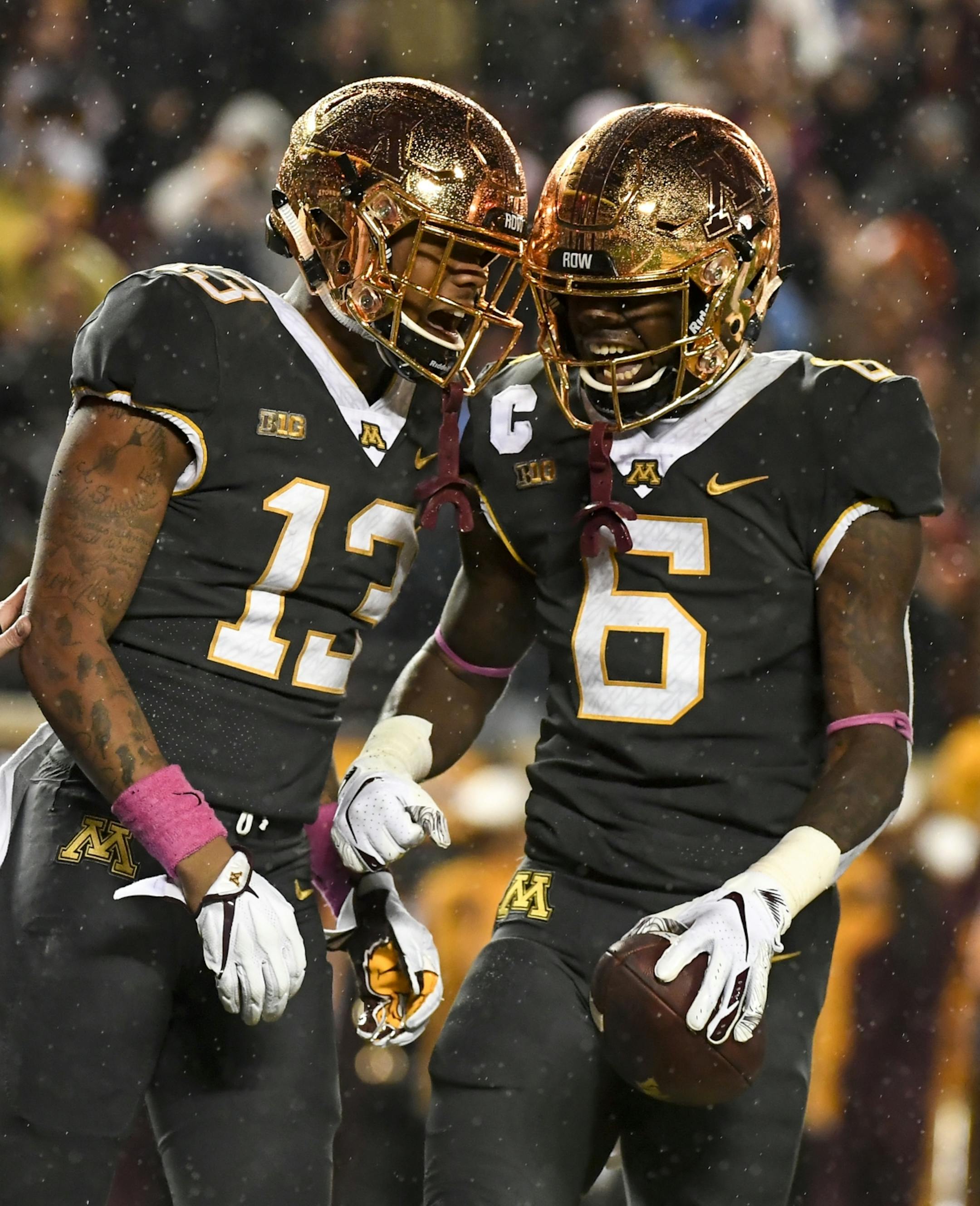 From left, Minnesota Golden Gophers wide receiver Rashod Bateman (13) and wide receiver Tyler Johnson (6) celebrated Johnson's second touchdown of the night Friday against the Indiana Hoosiers.