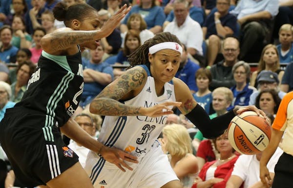 Lynx Seimone Augustus cut to the basket with Liberty's Alex Montgomery defending during the first half.